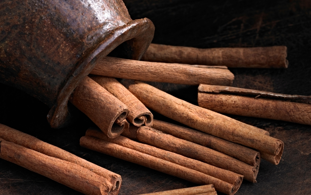 Cinnamon or cinnamon extracts are the best way to add that cinnamon flavor and brown tint in your drink.